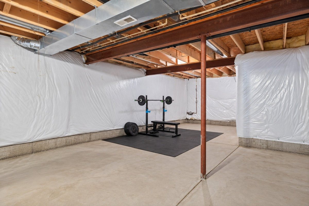 Full unfinished basement, currently set up as a home gym