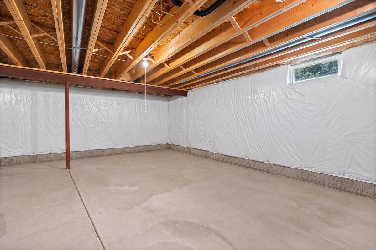 Full unfinished basement, digitally decluttered to show the space