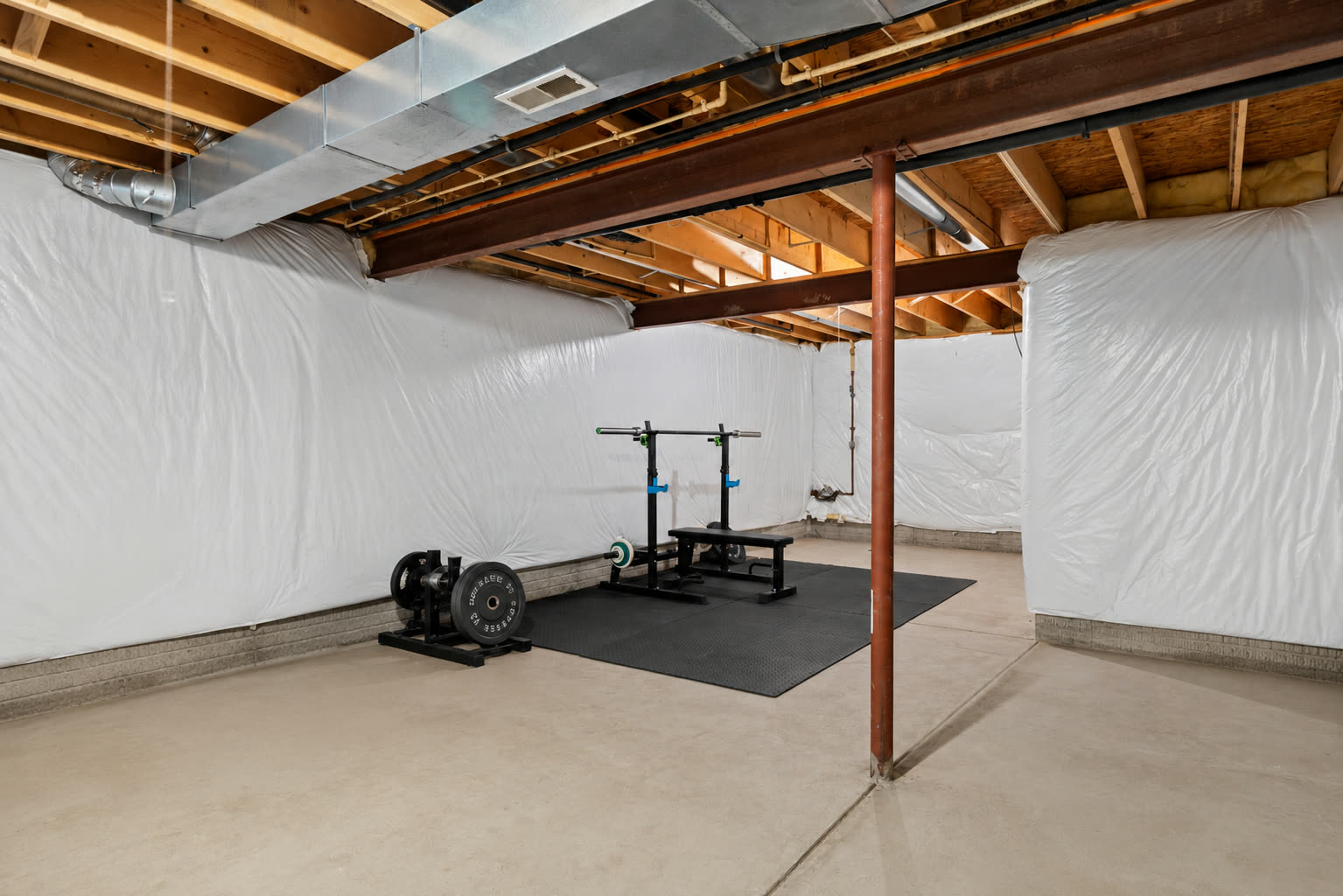 Unfinished basement with home gym at 5052 Forestland Ct