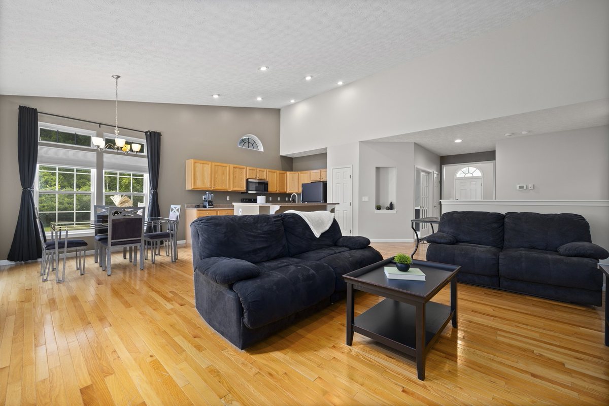 Open layout: great room, dining, and kitchen under one vaulted ceiling