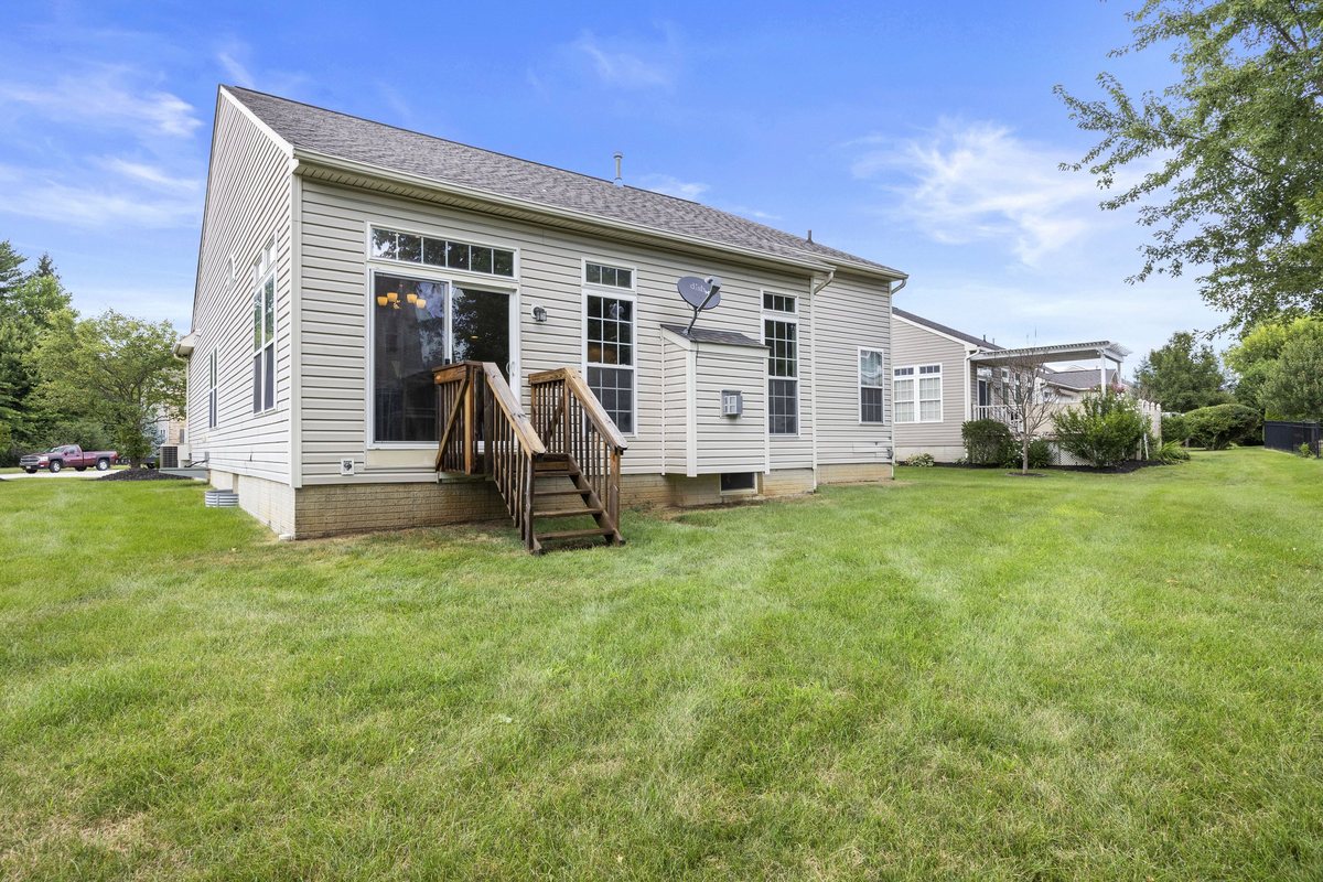 Rear exterior with deck and slider at 5052 Forestland Court