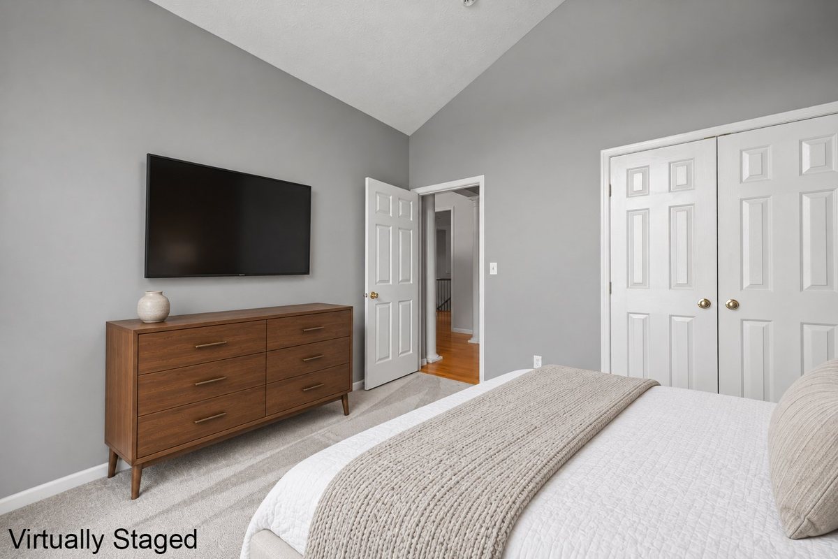 Second bedroom with double closet, virtually staged