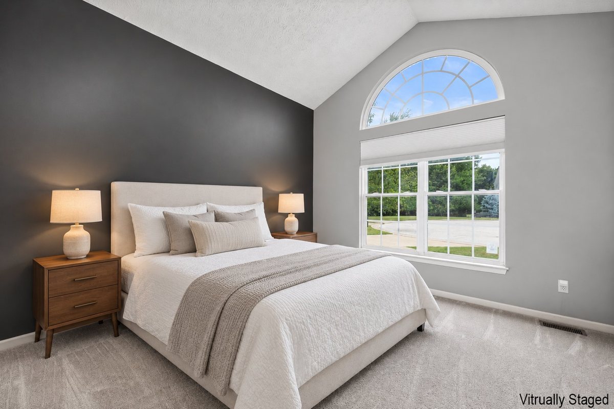 Second bedroom with arched window over Forestland Ct, virtually staged